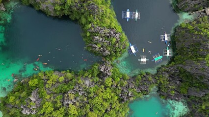 Wall Mural - Aerial top view of tropical island. Boats in blue lagoons, rocks cliffs mountains and coral reef, Philippines, 4k