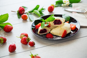 Wall Mural - cooked sweet homemade steamed dumplings with strawberries