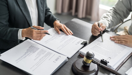 Lawyer Legal counsel presents to the client a signed contract with gavel and legal law. justice and lawyer Business partnership meeting concept