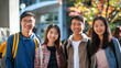 © Dirk - copy space, stockphoto, some asian college students in front of a school building. Back to school theme, friends meeting again after holidays.