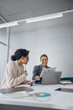 © Kostiantyn - Smiling business woman work together with documents to get the job done at the office