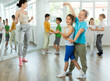 © JackF - Positive preteen children learning to dance waltz in pairs in choreography class
