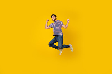 Sticker - Full length body photo of young adult bearded man jumping raised hands up enjoying freedom isolated over yellow color background