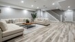 © Ilia Nesolenyi - A high-angle view of a recently renovated basement with contemporary design elements, including a large white sectional sofa and a gray-toned wood-look floor