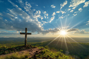 A cross on a hilltop overlooking a vast landscape, with sunrays breaking through scattered clouds and casting a soft glow over the scene below, creating a scene of tranquility and natural beauty