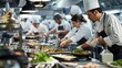 © Ilia Nesolenyi - A group of chefs and cooking instructors work diligently in a bustling commercial kitchen, preparing a variety of dishes