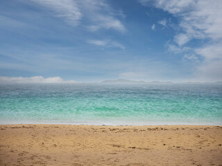 Wall Mural - Yellow sandy beach and tropical blue ocean water and stunning cloudy sky. West coast of Ireland. Irish landscape scene. Nobody. Travel and tourism. Calm and peaceful coastline.