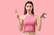 © Pixel-Shot - Beautiful young woman with birth control pills and alarm clock on pink background