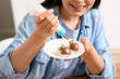 © Pixel-Shot - Young woman decorating chocolate covered strawberries, closeup