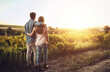 © Lyndon Stratford/peopleimages.com - Back, hug and couple in morning, countryside and together in field , love and date for anniversary. Sunrise, partner and person with embrace, nature and peace in grass and relax in Texas in farm