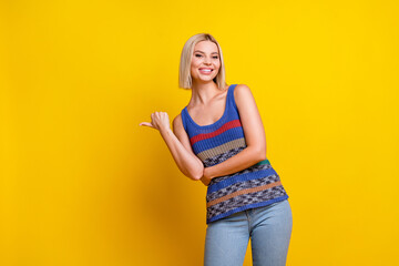 Wall Mural - Photo portrait of young beautiful woman promoter index finger empty space second hand store isolated on yellow color background