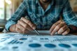 © gearstd - Close-up of man analyzing financial data
