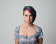 © faestock - a close up head and shoulders portrait of young alternative female model, with pink and grey shaved undercut hair style, wearing a floral blue top. dramatically pulling expressive facial expressions.