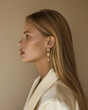 © Daisy - jewelry lookbook, side profile caucasian model with long blonde hair, her shoulders are relaxed, her ears are adorned with eye-catching earrings, cream background.