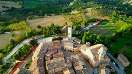 Wall Mural - Scenic aerial top-down pullback shot from Monte Vidon Corrado (FM), a complete vision of the old town centre and its characteristic buildings, church, belltower, tower, stairs, ring road, cars, trees