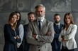 © VISUAL BACKGROUND - Businessman with beard standing with his arms crossed.