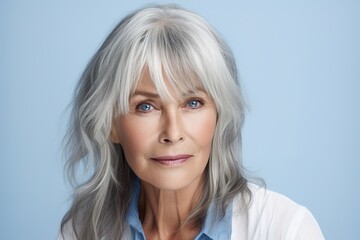 Wall Mural - A woman with long gray hair and blue shirt