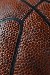 Wall Mural - A close-up view of a basketball sitting on a table, providing a clear focus on the ball's texture and color