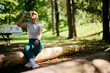 © Drazen - Thirsty sportswoman drinking water from  bottle while exercising in nature.