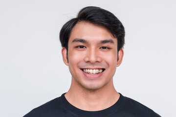 Handsome young asian man smiling in black shirt on white background