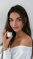 Beautiful smiling young woman with clean skin holding facial essential oil or serum with dropper, rejuvenation and skin care, white background