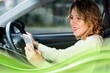 © Rawpixel.com - Woman using mobile phone while driving