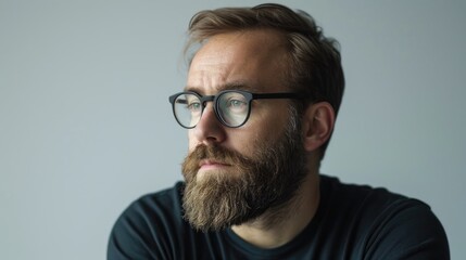 Poster - Confident man with beard and glasses thinking portrait against light gray background