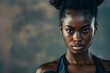 © Evan - Portrait of a fit black sportswoman with kettlebell in her hands looking at the camera.