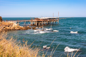 Traditional wooden fishing house with a net near sea coast