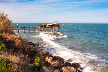 Wall Mural - Traditional wooden fishing house with a net near sea coast