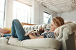 © peopleimages.com - Dog, sofa or happy woman in home to relax on living room couch in house, lounge or apartment. English spaniel puppy, resting or person with love, wellness or support for bonding with calm pet animal