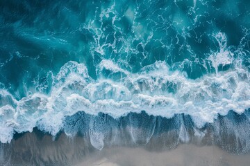 Wall Mural - A beautiful image of the natural beauty of the sea element - turquoise waves with white foam caps roll onto a sandy beach.