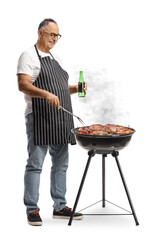 Poster - Mature man holding and a bottle of beer and making a bbq