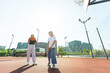© Angelov - Teenager girl street basketball player with ball on outdoor city basketball court.