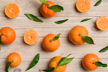 Wall Mural - Many fresh ripe mandarin as colored background, top view. Elegant background of clementines and mandarin slices Top view flat lay