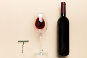 Flat lay composition with corkscrew, bottle of wine and elegant glass on colored table. Flat lay, top view wth copy space