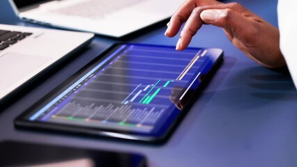 Poster - African American woman using Gantt software to manage project schedule and control finances on computer