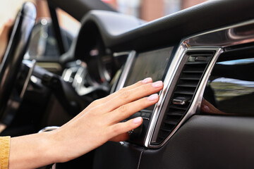 Wall Mural - Woman checking air conditioner in her car, closeup