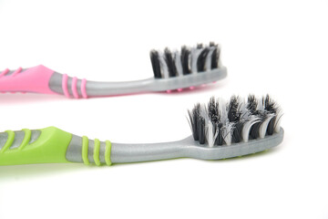 Wall Mural - Old toothbrush that has been used and is worn out isolated on white background. Oral and teeth cleaning equipment.