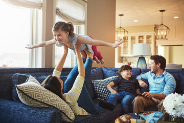 Airplane, playing and children with parents on sofa in home relaxing with care, happiness and love together. Smile, bonding and girl kid with flying role play with mom, brother and dad in living room