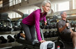 © ReadyAtTheEase/peopleimages.com - Workout, weights and senior woman in gym for fitness, training and cardio exercise with music. Retirement, sports and person with dumbbells for wellness, muscle strength and mobility for health