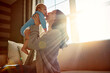 © ReadyAtTheEase/peopleimages.com - Mother, baby and kiss on cheek in living room on sofa with love for relationship with new born, care. Embrace, light and sunshine for relax on couch with playing, joy and happiness for wellness.