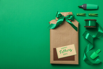 Wall Mural - Gift wrapping for Father's Day, on a green background.