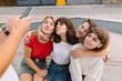 © anatoliycherkas - Best friends taking selfie outdoors with backlighting - Happy friendship concept with teenagers having fun together.