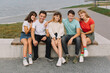 © anatoliycherkas - Summer holidays and teenage concept - group of smiling teenagers hanging out outside.