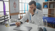 © Krakenimages.com - A stressed male doctor in a clinic office with stethoscope, feeling exhausted and holding his head.