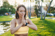 © Strelciuc - Mature fit woman practicing yoga outside in natural calm green environment in park meditating with folded palms in front her. Sitting prayer pose. Yoga