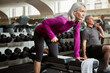 © ReadyAtTheEase/peopleimages.com - Workout, weights and senior woman in gym for fitness, training and cardio exercise listen to music. Retirement, sports and person with dumbbells for wellness, muscle strength and mobility for health