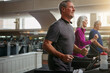 © peopleimages.com - Class, gym or senior man on treadmill in workout or training for challenge, health or wellness. Runner, retirement or happy elderly person on running machine for fitness, energy or cardio exercise