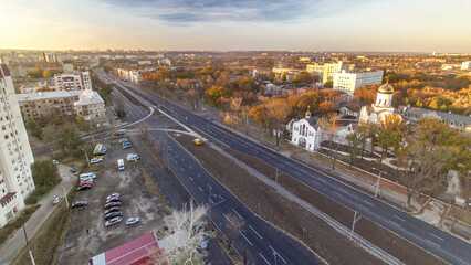 Wall Mural - Aerial vivid colorful sunset view with road traffic skyscape timelapse. Kharkiv city from above